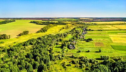 Wall Mural - Aerial landscape of the Central Russian Upland. Shuklino village, Kursk region.