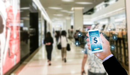 Mock up image of woman hand holding and using mobile smart phone with blank white scree in shopping mall center blur background.Mobile application,mobile banking,online shopping concept. Clipping path