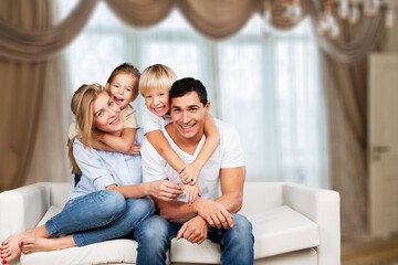 Canvas Print - Beautiful smiling lovely family sitting on sofa