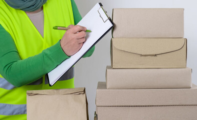 Wall Mural - hand deliver worker delivery green vest gift box blank order form waybill