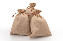 Agricultural Hessian Cloth Sacks, Rough Sack Material And Linen Fabric Textile Concept With Pile Of Three Brown Burlap Or Sackcloth Bags Isolated On White Background With Clipping Path Cutout
