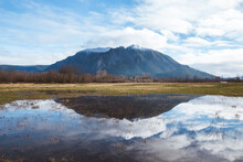 Water Reflection Of Snow Capped Mount Si In Clouds