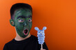 © Ильназ Багаутдинов - Frankenstein boy and a blue marshmallow on a stick. the concept of Halloween