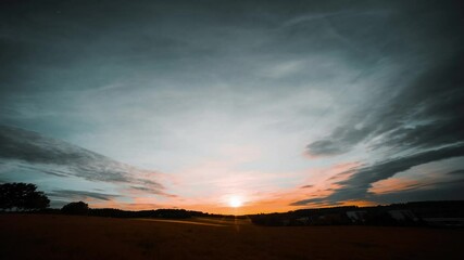 Canvas Print - Clouds in the sky Sunset on a summer meadow Time lapse