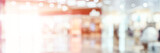 Fototapeta Zwierzęta - Empty blurry mall background. DeFocused wallpaper. Business office interior. Light lifestyle supermarket. Bokeh effect. Holiday backdrop. Copyspace for text. Ready for card or site design