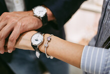 Beautiful Couple Enjoying In Shopping At Modern Jewelry Store. Close Up Shot Of Human Hand Holding Expensive Watch.