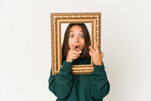Young Hispanic Woman Holding An Old Frame Having An Idea, Inspiration Concept.