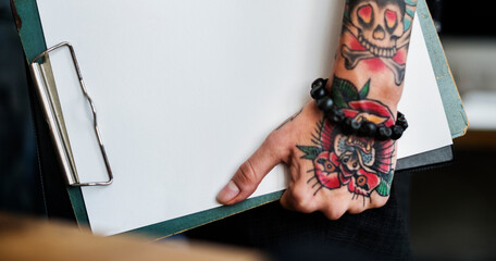 Wall Mural - tattooed hand holding a blank paper clipboard website banner template