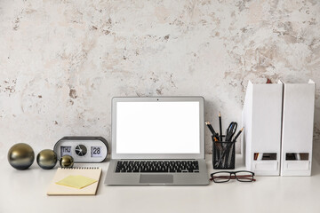 Comfortable workplace with modern laptop in room
