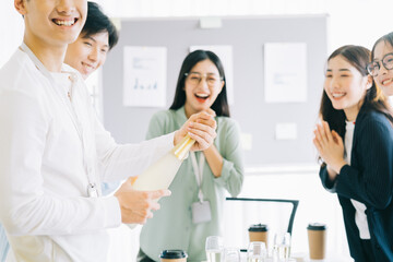 Sticker - Asian businessman is opening champagne to celebrate the new year with the members of the business group