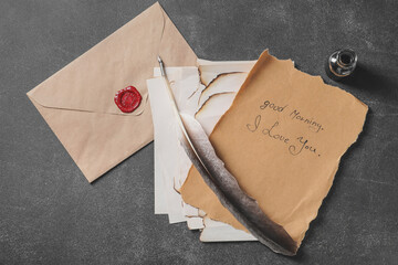 Vintage letter and envelope with feather pen on table