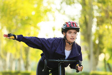 Female Cyclist Riding Bicycle Outdoors