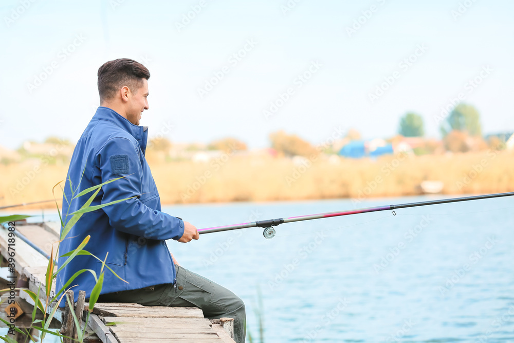 Young man fishing on river