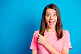 Fototapeta  - Photo portrait of amazed surprized female student pointing finger at blank space smiling isolated on vibrant blue color background