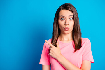 Wall Mural - Photo portrait of impressed amazed brunette girl whistling showing at copyspace isolated on bright blue color background