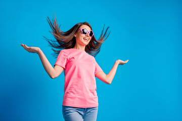 Poster - Photo portrait of young pretty woman throwing hair dancing smiling wearing casual clothes isolated on vivid blue color background