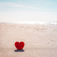 Romantic Symbol Of Red Heart On The Sand Beach