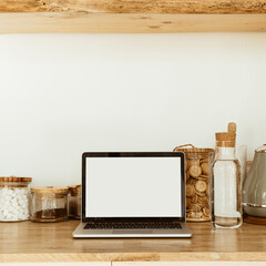 Wall Mural - Workspace with mockup blank copy space screen laptop in kitchen. Modern stylish interior design. Front view food blog, social media, website template.