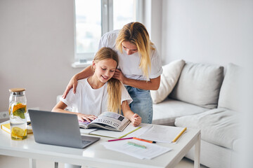 Wall Mural - Mother encouraging a daughter for better studying