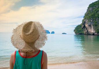 A Boy wearing beach hat for holiday at the sea