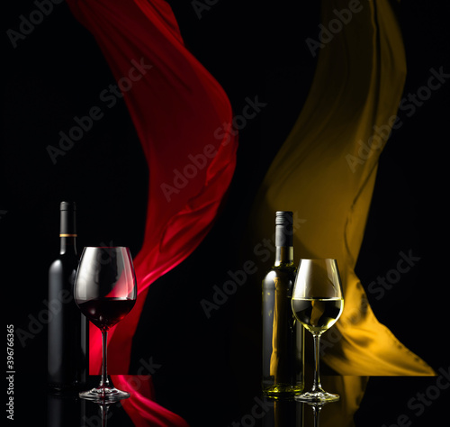Photo Red and white wine on a black reflective background.