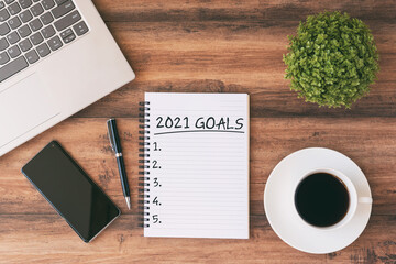 Wall Mural - 2021 goals text on Note Pad With Laptop, Smartphone, Pen and Cup of Coffee