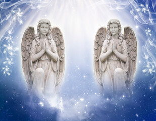 Wall Mural - two praying angels with god´s rays of light over blue universe background