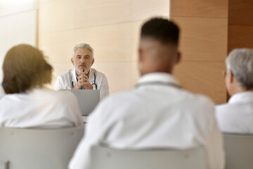 doctor giving lecture to medical students at the hospital