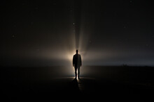 Backlighting Of A Man In The Dark Of A Foggy Night And A Light Behind The Model