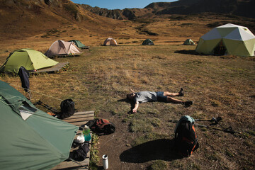 man resting in a tent camp