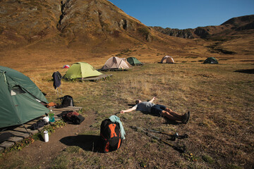 man resting in a tent camp