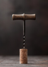 Wine Cork With Vintage Corkscrew On Top On Wood Background.