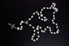 White Rosary On Black Background, View From Above
