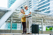 © ART STOCK CREATIVE - Elderly Asian couples,tourists standing looking at map showing routes in capital of business districts and planning travel plans with concept of traveling around the world after retirement from work.