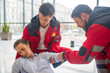 © zinkevych - Ambulance crew giving first aid to the faint woman
