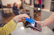 © Monkey Business - Close Up Of Senior Woman Making Contactless Payment To Stylist In Salon With Credit Card