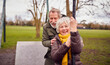 © Monkey Business - Senior Couple Having Fun Playing On Swing In Park Playground
