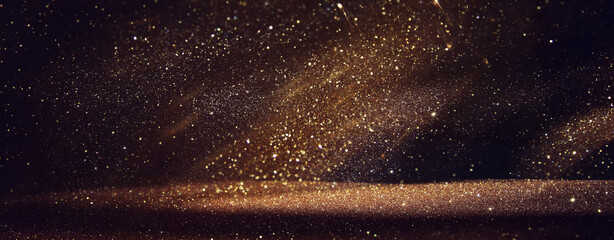 background of abstract gold and black glitter lights. defocused