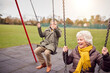 © Monkey Business - Senior Couple Having Fun Playing On Swings In Park Playground