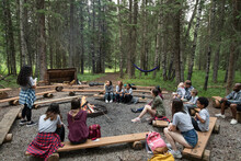 Children Sitting In Forest Summer Camp