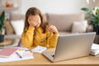 © Arsenii - Portrait of sad kid girl tired from studying, learning online from home with laptop, holding eyeglasses in her hand, exhausted with school homework. Homeschooling, distance education due to covid-19