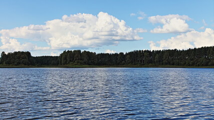 Poster - Russian riverscape view beautiful river water, green forest line on horizon and blue sky with white clouds at summer day, natural river landscape, ecological outdoor active tourism recreation