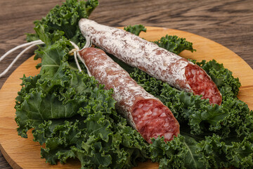 Spanish Fuet sausage with salad leaves