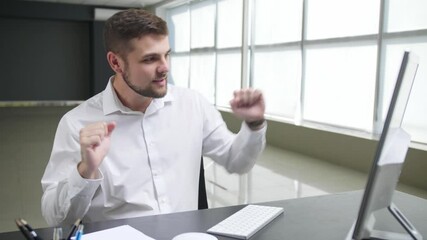 Canvas Print - Dancing man sitting at workplace in office