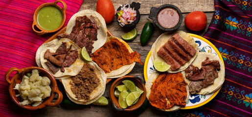 Assortment of mexican tacos on wooden background