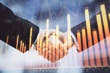 Double exposure of forex graph hologram and handshake of two men. Stock market concept.