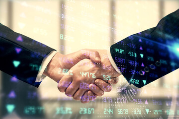 Double exposure of forex graph hologram and handshake of two men. Stock market concept.