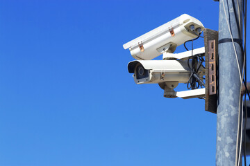 Security surveillance cameras installed on poles outside the building are used for area control.