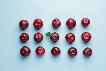 Fresh ripe plums on  color background