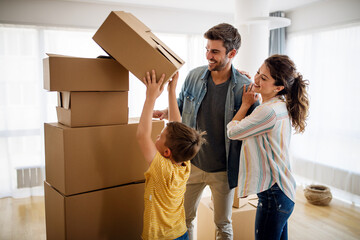 Wall Mural - Happy family with cardboard boxes in new house at moving day.